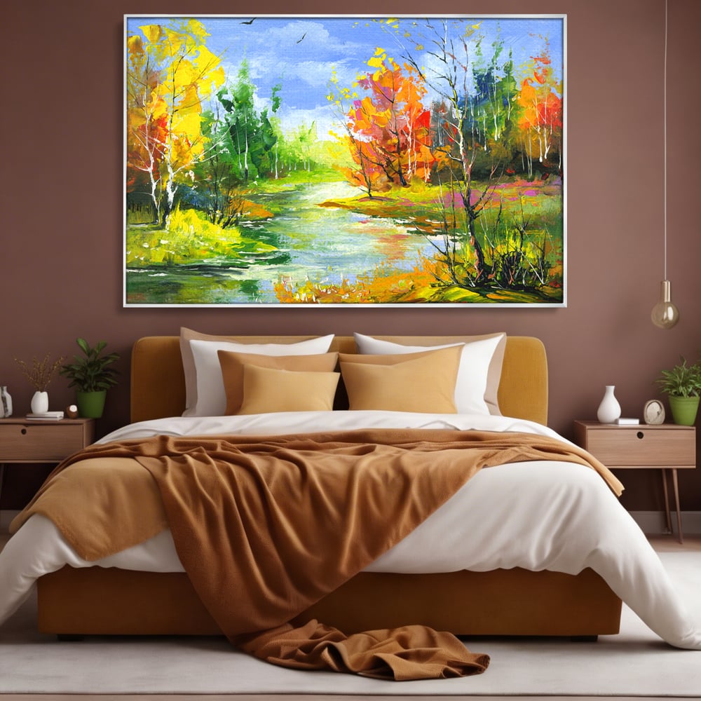 Tablou canvas cu pictura peisaj de toamna cu rau, in rama de aluminiu argintiu, pe perete intr-un dormitor
